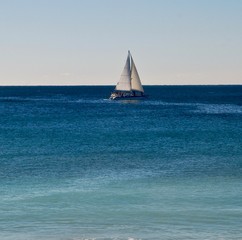 White sailboat on the blue Atlantic ocean
