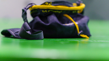 Chalckbag on a green floor in a  boulderhall 