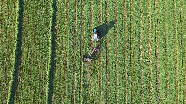 Agricultural Tractor With Tedder Turns Hay On The Agricultural Field For Drying