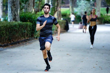 Athlete running in the park. Young people workout outdoor. Healthy life and sport lifestyle concept
