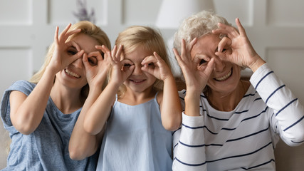 Happy three generations female family having fun together at home.