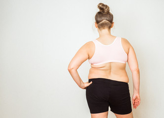 Woman with fat abdomen, overweight female stomach, stretch marks on belly closeup, white background