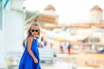 Adorable little girl at Little Venice the most popular tourist area on Mykonos island, Greece.