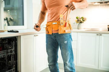 Plumber standing in the kitchen at home