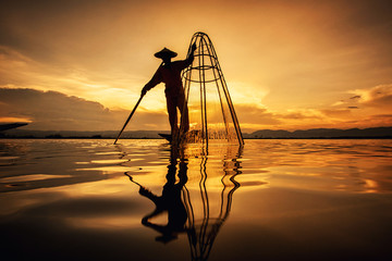 Intha Burmese fishermen on boat catching fish traditional at Inle Lake, Shan State, Myanmar