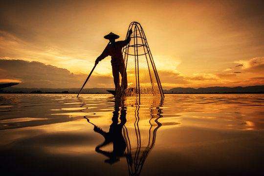 Intha Burmese fishermen on boat catching fish traditional at Inle Lake, Shan State, Myanmar