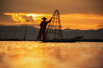 Intha Burmese fishermen on boat catching fish traditional at Inle Lake, Shan State, Myanmar