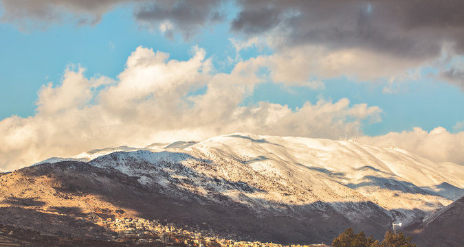 Snow on Hermon mountain with blue sky and clouds landscape view