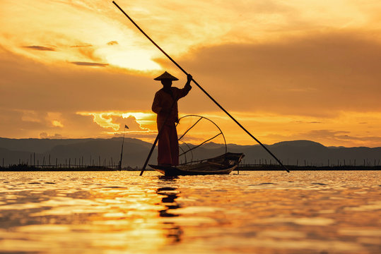 Intha Burmese fishermen on boat catching fish traditional at Inle Lake, Shan State, Myanmar - Powered by Adobe