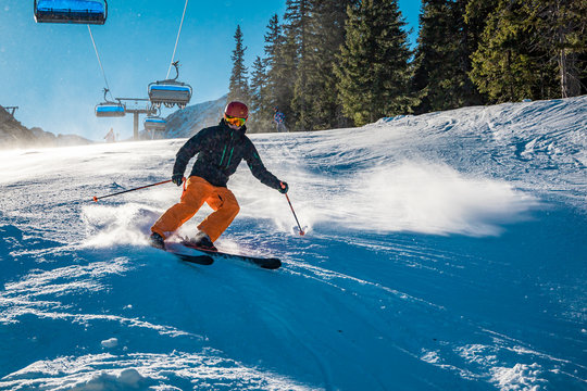 Young skier braking with a smile on his face