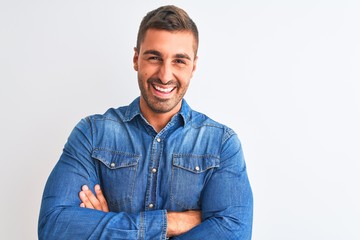 Fototapeta premium Young handsome man wearing denim jacket standing over isolated background happy face smiling with crossed arms looking at the camera. Positive person.