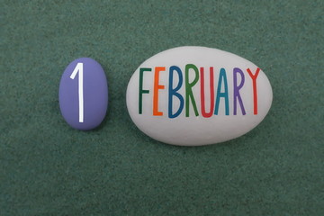 1 February, calendar date composed with colored and carved stones over green sand