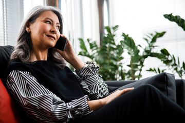 Calm woman listening to business partner on the phone stock photo