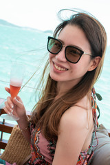 Woman wearing sunglasses beside the sea