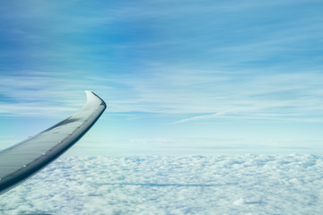 Fototapeta na wymiar Wing of the plane on blue sky