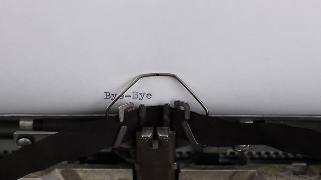 close-up typing text bye-bye, old vintage typewriter with a sheet of paper