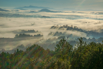 beautiful landscape of Da Lat ci ty, the pin hill and the buiding in fog and sun