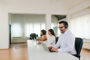 Beautiful people working in modern customer support office.