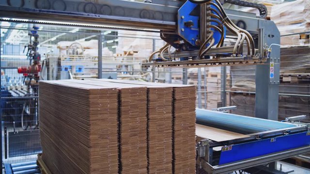 Automated equipment for laminate production. Modern robotic factory indoors. Woodworking production.