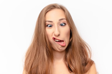 young pretty woman looking goofy and funny with a silly cross-eyed expression, joking and fooling...