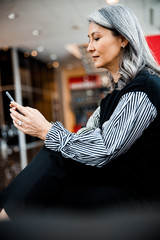 Calm woman sending messages to her friend stock photo
