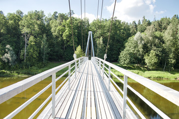  Pedestrian cable bridge over river Gauja in Sigulda. The bridge provides scenic views of the river and surroundings and connects several sights of interest for tourists