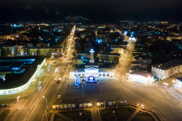 Fototapeta premium Night view of city center Kostroma with car traffic and illuminated Fire tower, Russia
