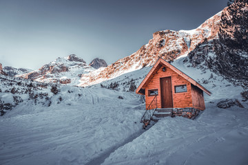 Small wooden chalet in front of Malyovitsa peak- one of the highest peaks in Rila mountain, Bulgaria