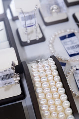  retail gold store showcase displaying  luxury pearls  jewerly