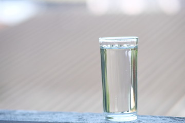 glass of water with ice on blue background