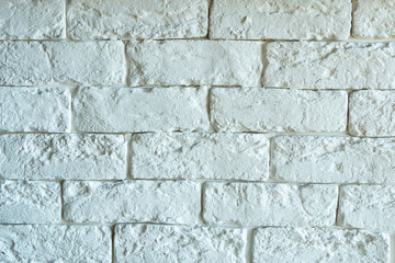 The texture of a white brick wall with small bricks.