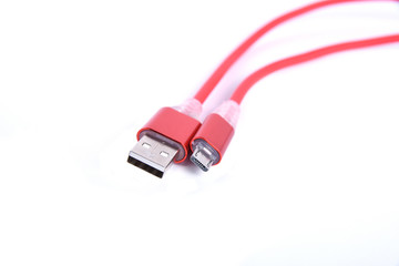 Red USB cable for smartphone charge isolated on white background.