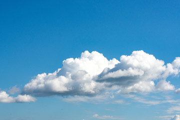 Luminous clouds set against a dark blue sky in the sun. Wonderful blue glowing cloud