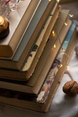 Walnut next to a pile of books. Old books. Close-up. Book pages