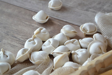 Domestic raw dumplings on the table. Russian culture, still life