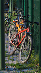 Fototapeta na wymiar Parked bike near the Playground. Environmentally friendly mode of transport is parked at the Playground
