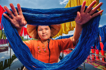 Burmese dry thread the Handmade colourful lotus fabrics at Inle Lake, Shan State in Myanmar.