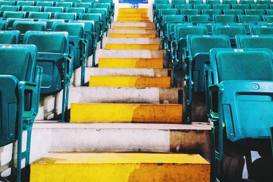 Steps Amidst Empty Bleachers At Stadium During Sunny Day