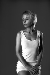 portrait of a young woman on a dark background looking away, black and white photo