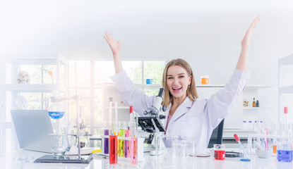 pretty scientist work reserching and cheerfully in a chemical laboratory