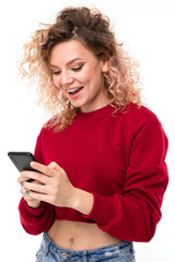 Fototapeta premium Emotional caucasian girl with curly fair hair chatting with friends and smiles.