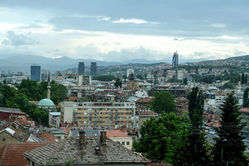 Panorama of the city center of Sarajevo, Bosnia and Herzegovina, seen from above. The major landmarks of the old towns, such as mosques, and skyscrapers are visible, during a cloudy rainy afternoon