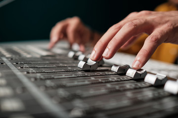 Man with stage mixer controller for audio