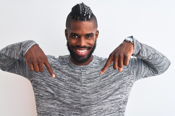 African american man with braids wearing grey sweater over isolated white background looking...