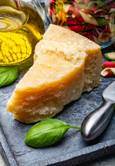 Cheese collection, piece of hard aged Italian parmesan or grana padano cheese with olive oil and tricolore italian pasta