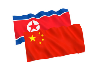Flags of North Korea and China on a white background