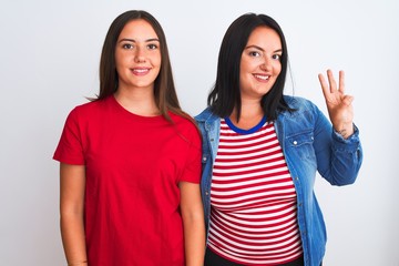 Young beautiful women wearing casual clothes standing over isolated white background showing and pointing up with fingers number three while smiling confident and happy.