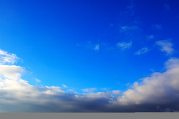 Blue sky with large clouds and sunlight. Nature background.