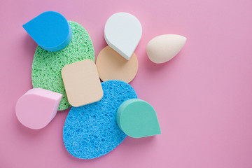 make up cosmetic sponges assorted shape on pink background