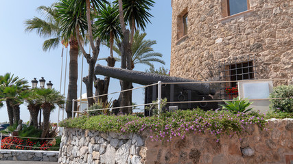 historic cannon in the port of marbella, spain